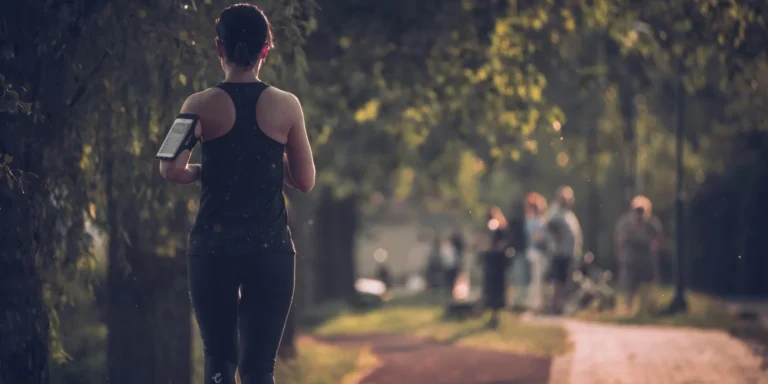 A woman running on a trail.