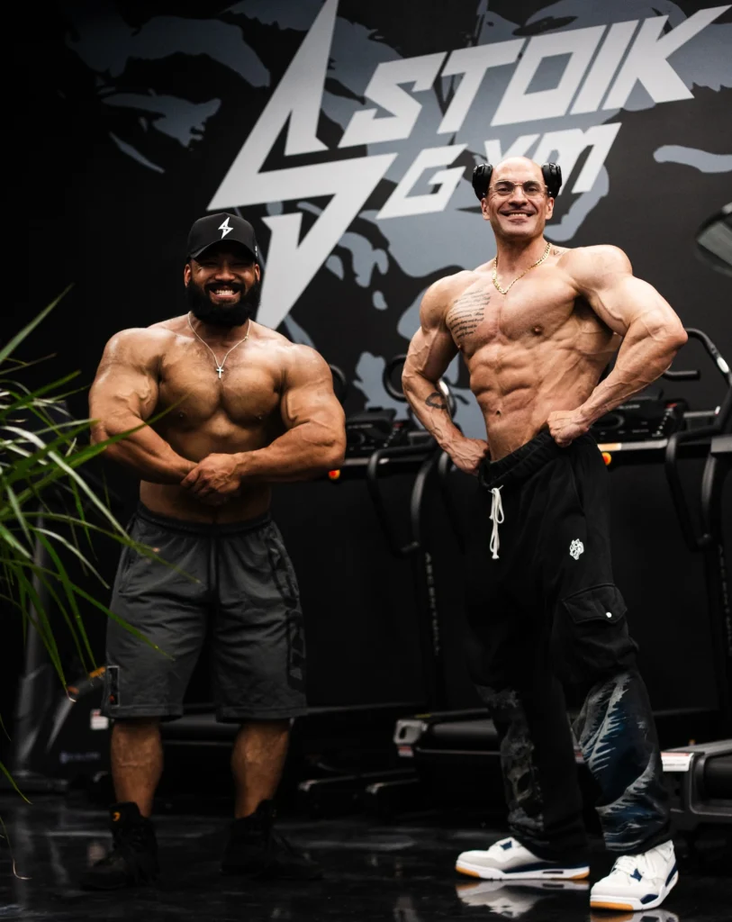 two bodybuilders pose inside a Stoik Gym