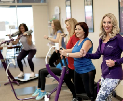 a group of women work out at a Curves gym