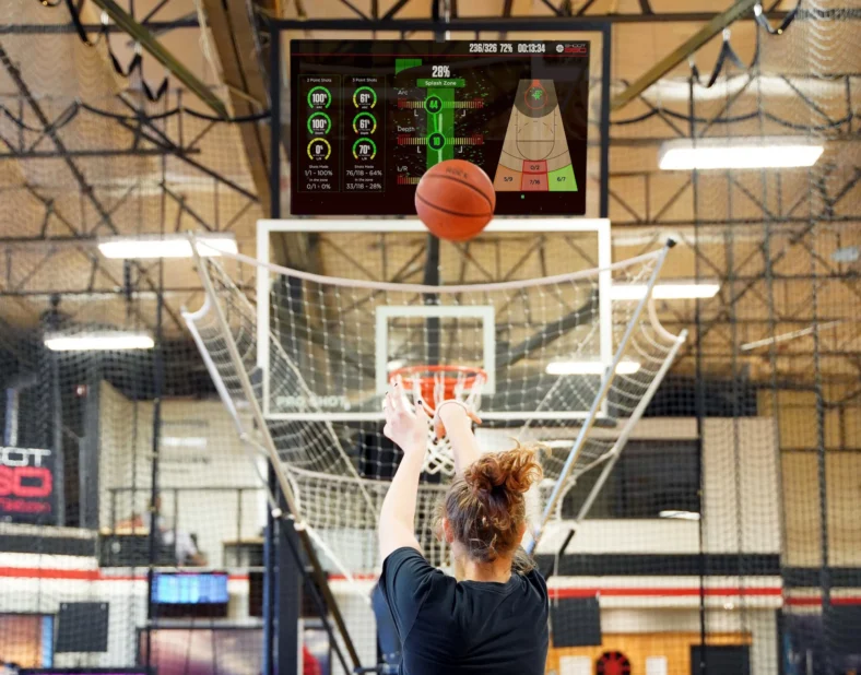 girl shoots on a Shoot 360 basket