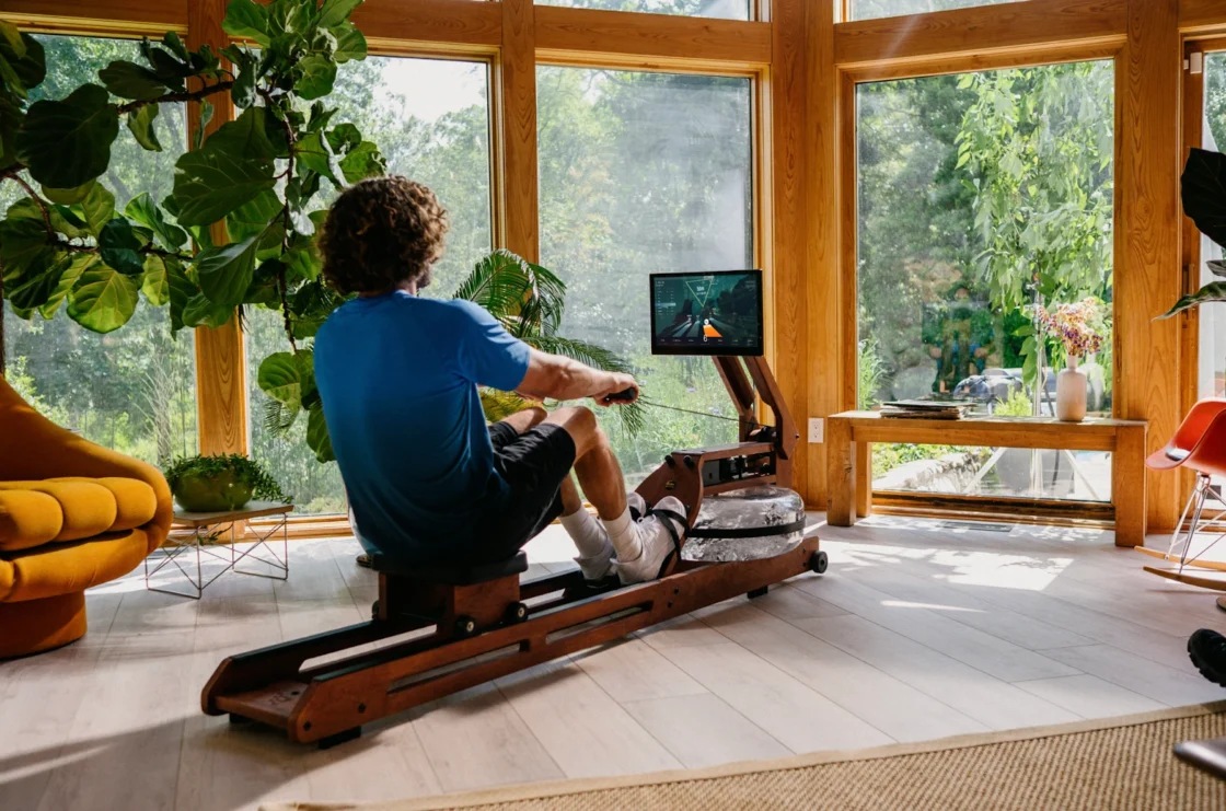 man uses an Ergatta rower